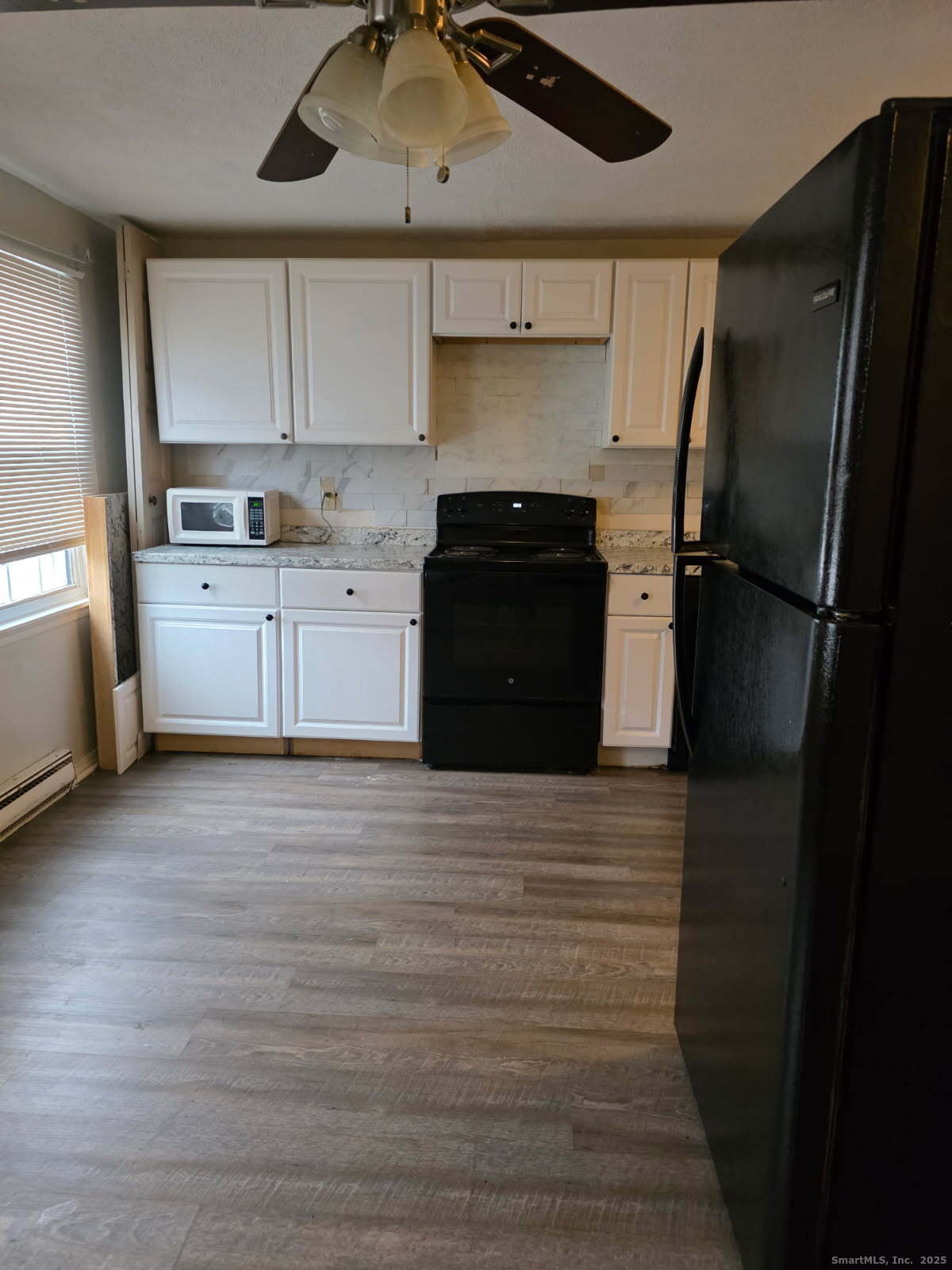 20 Lakeside Drive, Unit P Ledyard, CT 06339 - Photo 18 of 19 a kitchen with a refrigerator and white cabinets