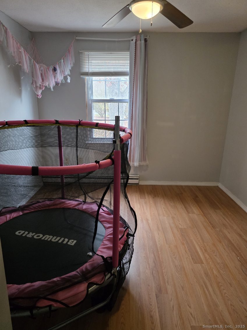 20 Lakeside Drive, Unit P Ledyard, CT 06339 - Photo 4 of 19 a room with wooden floor and window