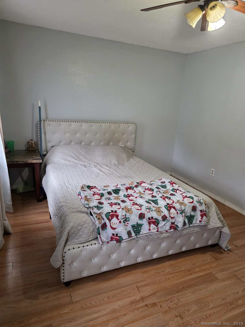 20 Lakeside Drive, Unit P Ledyard, CT 06339 - Photo 9 of 19 a bedroom with a bed and wooden floor