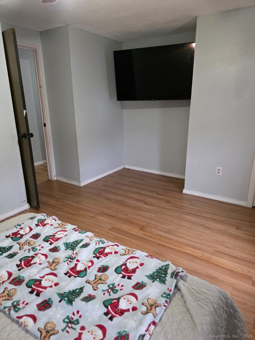 20 Lakeside Drive, Unit P Ledyard, CT 06339 - Photo 10 of 19 a bedroom with a bed and a bookshelf