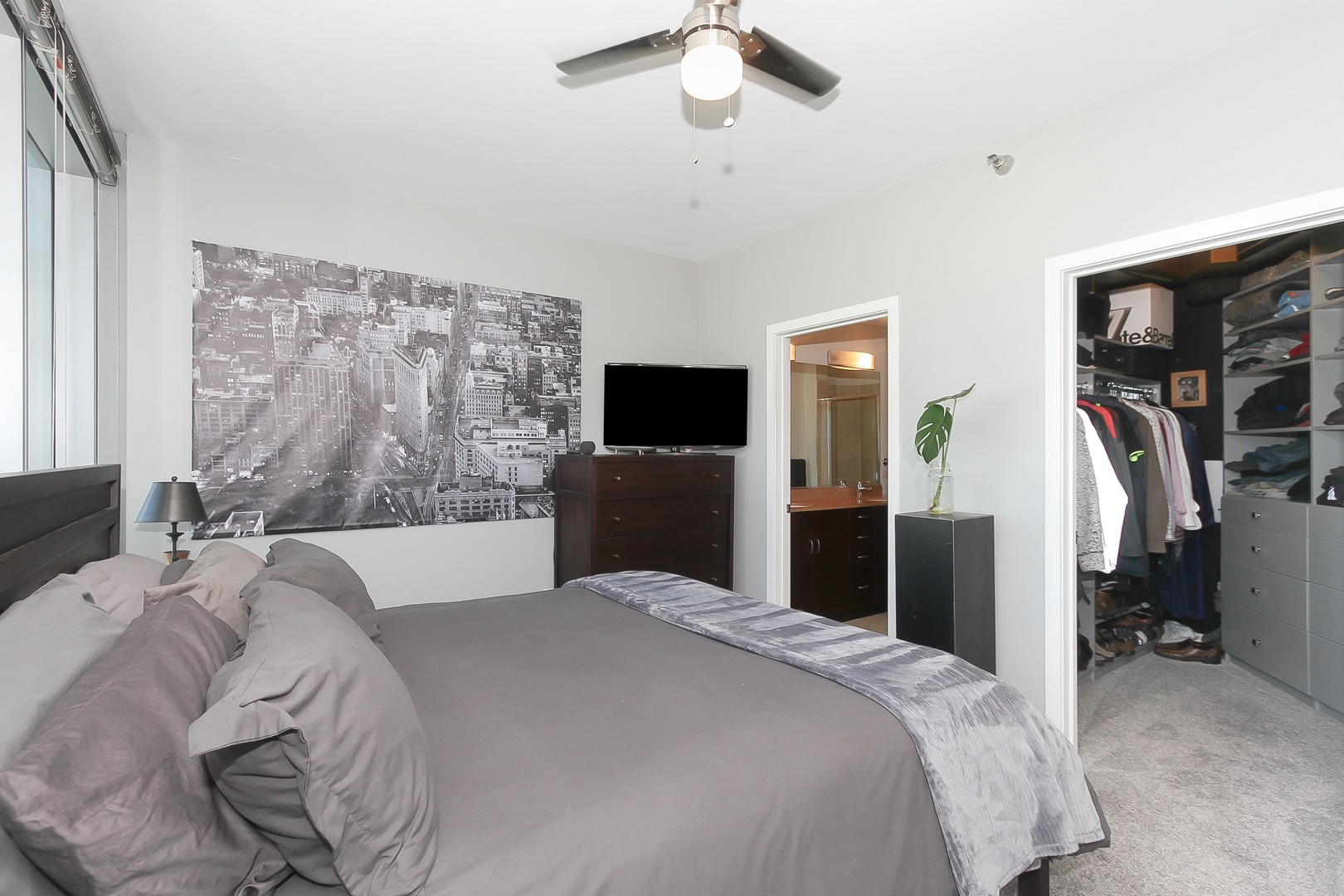 123 South Green Street, Unit 801B Chicago, IL 60607 - Photo 12 of 20 a bedroom with a bed and a flat tv screen on dresser