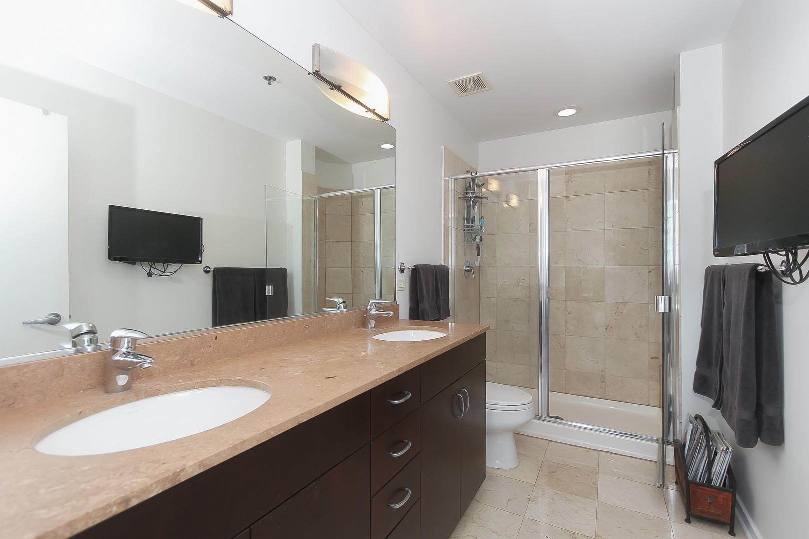 123 South Green Street, Unit 801B Chicago, IL 60607 - Photo 13 of 20 a bathroom with a sink a large mirror and a shower