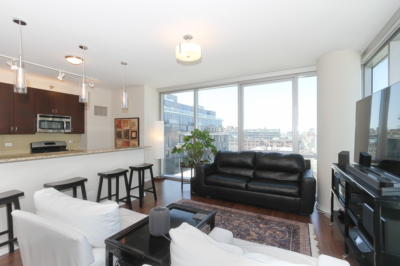 123 South Green Street, Unit 801B Chicago, IL 60607 - Photo 4 of 20 a living room with furniture a flat screen tv and a large window