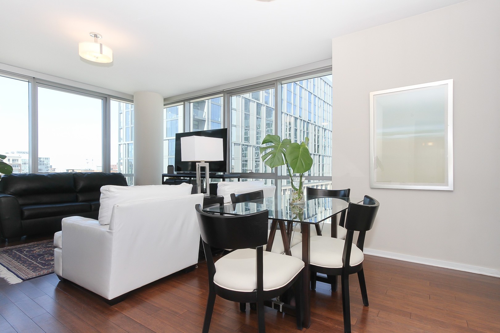 123 South Green Street, Unit 801B Chicago, IL 60607 - Photo 6 of 20 a view of a dining room with furniture window and wooden floor