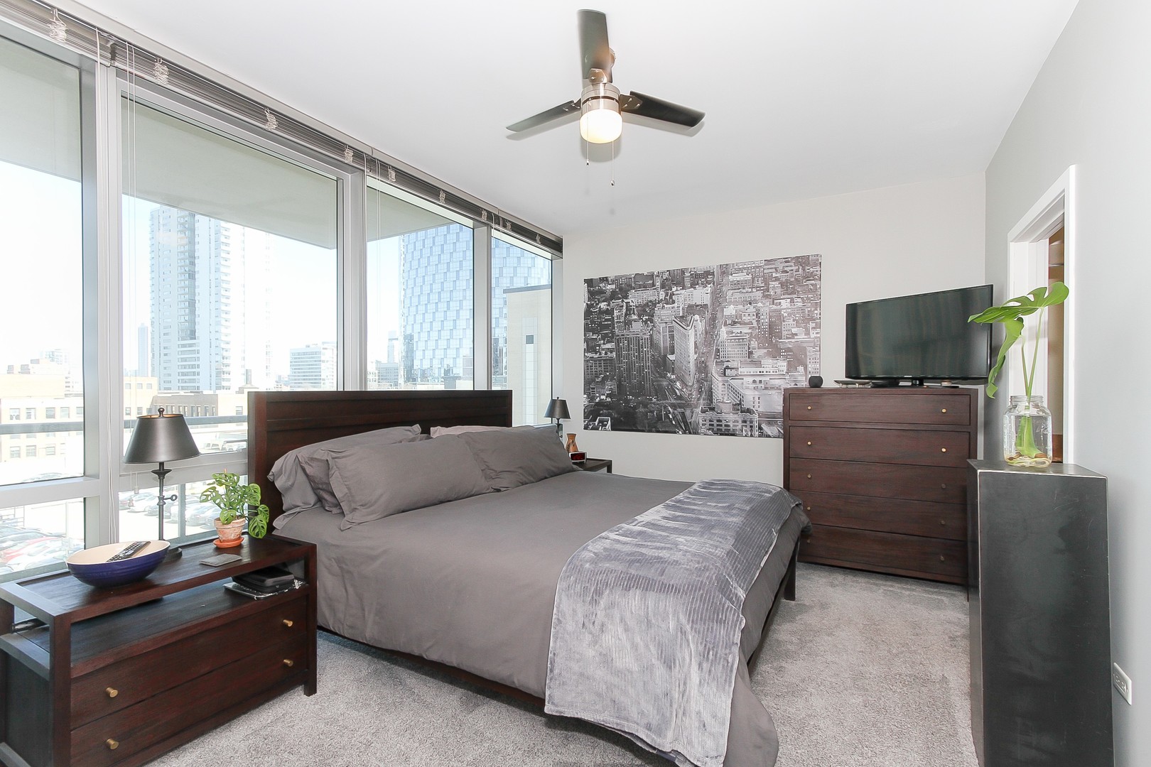 123 South Green Street, Unit 801B Chicago, IL 60607 - Photo 10 of 20 a bedroom with a bed flat screen tv and a large window