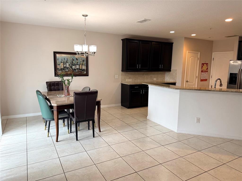 2084 Water Tupelo Way Ocoee, FL 34761 - Photo 5 of 34 a view of kitchen with furniture and flat screen tv