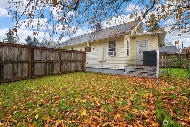 a view of a backyard with wooden fence