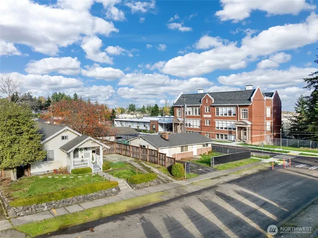 an aerial view of residential houses with outdoor space and street view