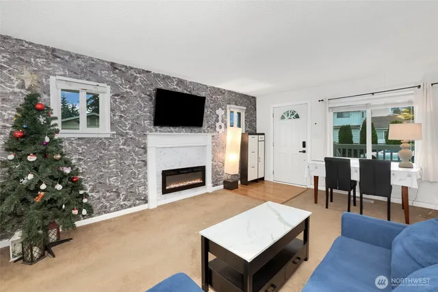 a living room with furniture a flat screen tv and a fireplace