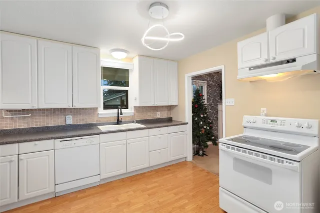 a kitchen with a sink cabinets and window