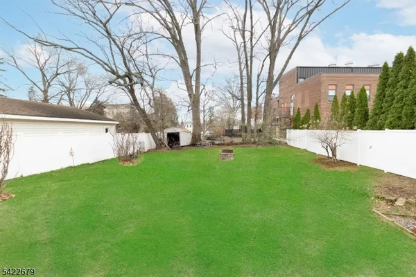 a view of yard with swimming pool and green space