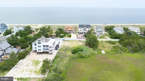 an aerial view of a house with a yard basket ball court and outdoor seating