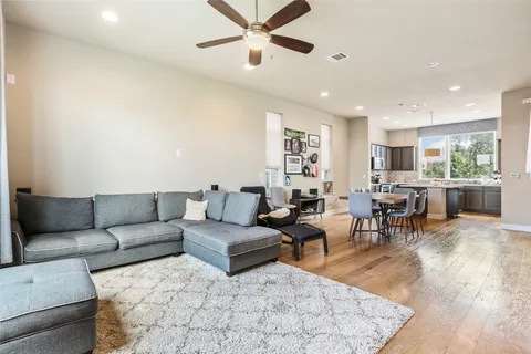 a living room with furniture and wooden floor