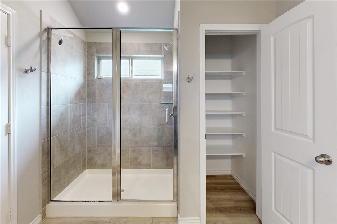 2010 Chief Street Bryan, TX 77807 - Photo 25 of 29 a bathroom with a glass shower door