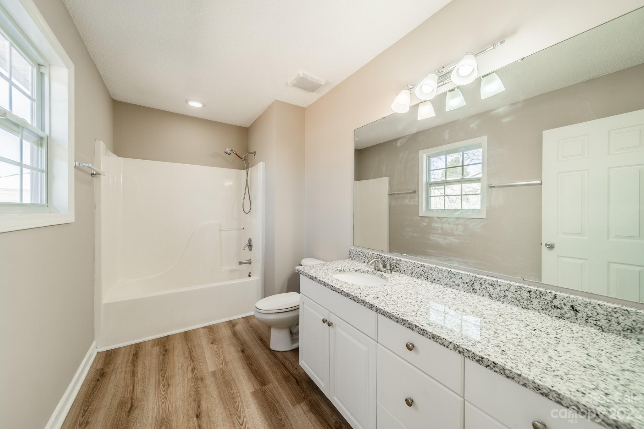 300 Walkers Ridge Drive Shelby, NC 28152 - Photo 12 of 15 a spacious bathroom with a granite countertop sink a mirror and a shower