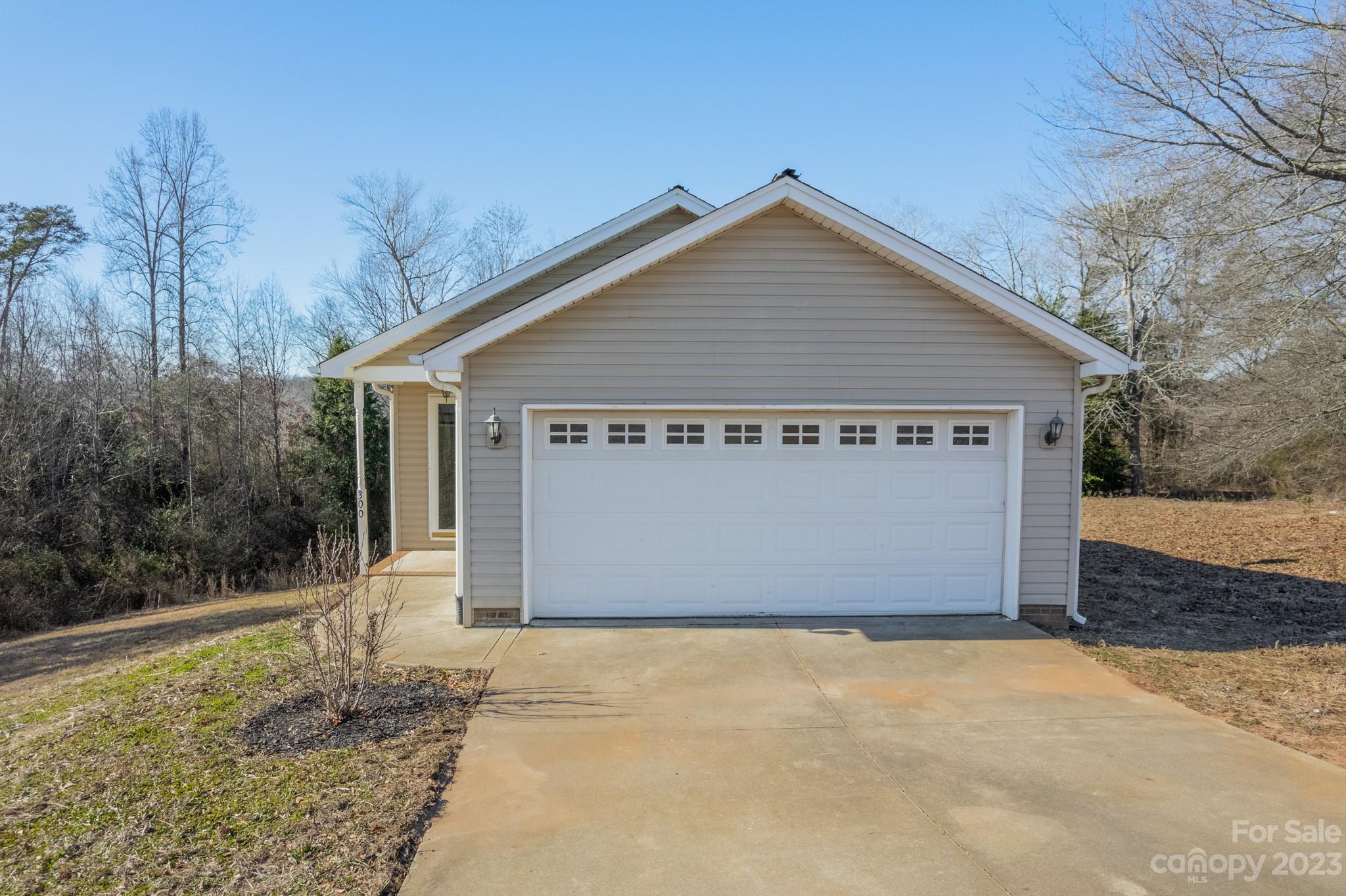 300 Walkers Ridge Drive Shelby, NC 28152 - Photo 2 of 15 a view of a house with a yard and garage