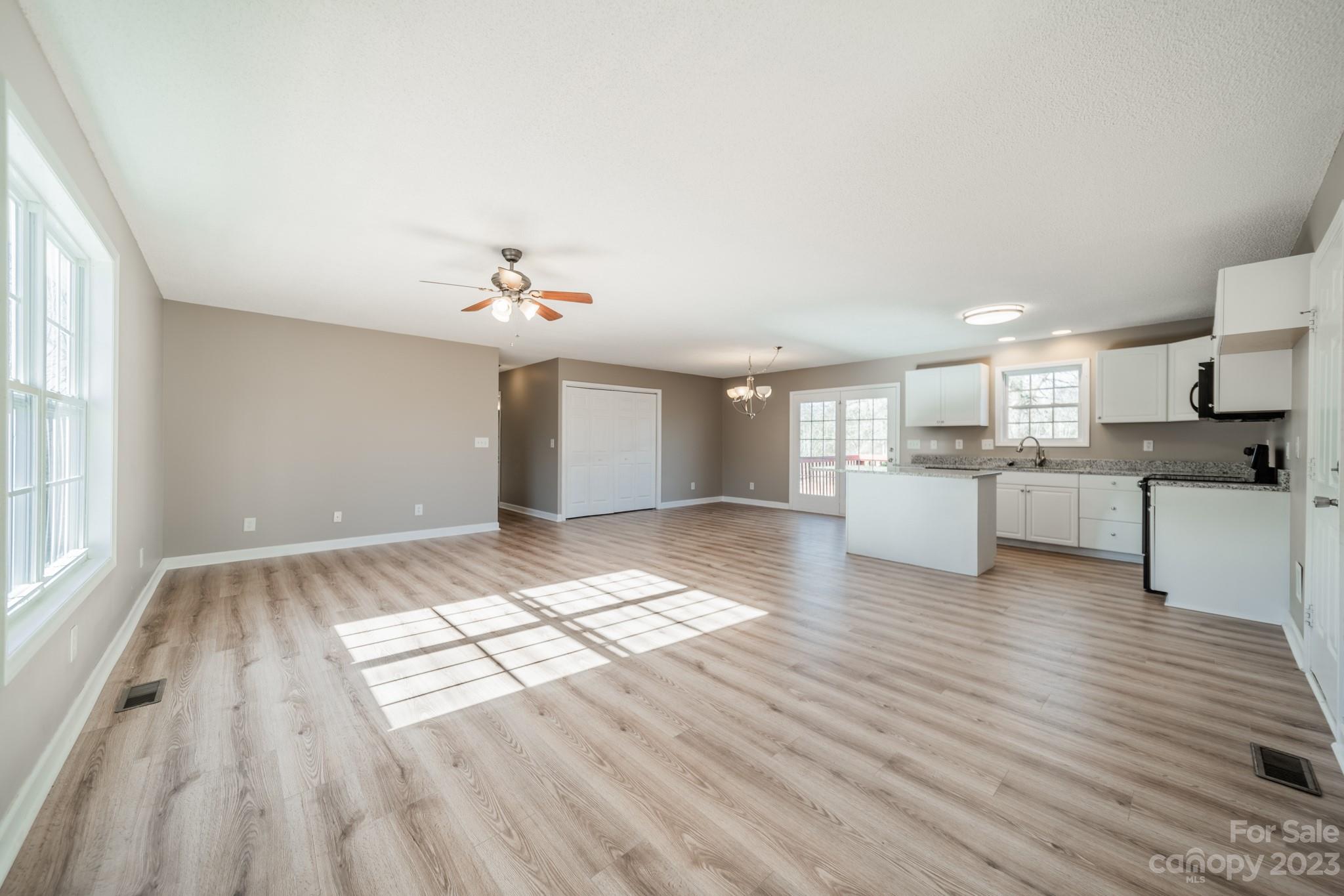 300 Walkers Ridge Drive Shelby, NC 28152 - Photo 3 of 15 a view of a living room a kitchen with wooden floor and window