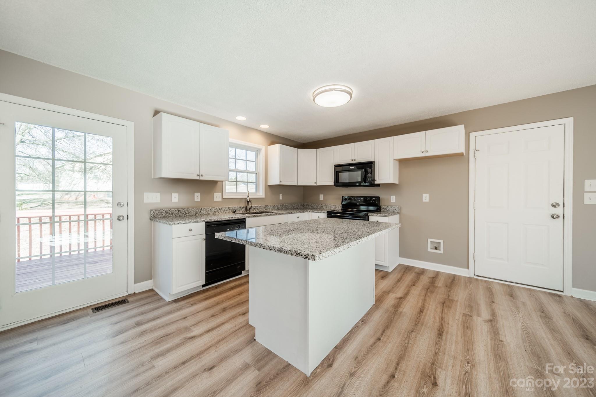 300 Walkers Ridge Drive Shelby, NC 28152 - Photo 6 of 15 a kitchen with stainless steel appliances granite countertop a refrigerator a sink dishwasher a stove and white countertops with wooden floor