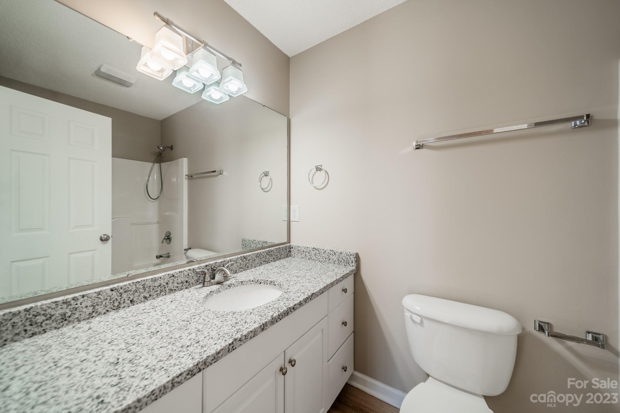 300 Walkers Ridge Drive Shelby, NC 28152 - Photo 8 of 15 a bathroom with a granite countertop sink a toilet and a mirror