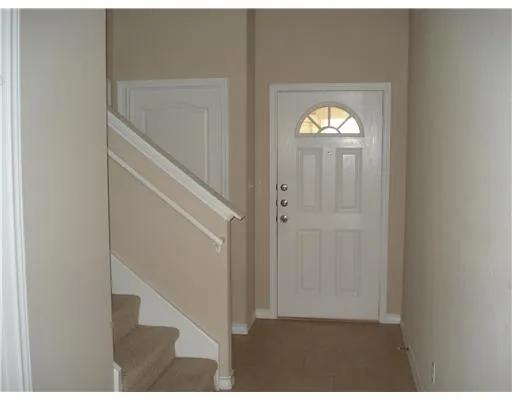 a view of a hallway with windows and stairs