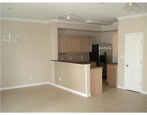 15209 South Padre Island Drive, Unit 104 Corpus Christi, TX 78418 - Photo 4 of 6 a kitchen with a refrigerator and a sink