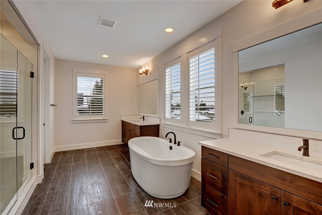 21634 35th Avenue Southeast, Unit 20 Bothell, WA 98021 - Photo 4 of 14 a bathroom with a sink a toilet a mirror and window