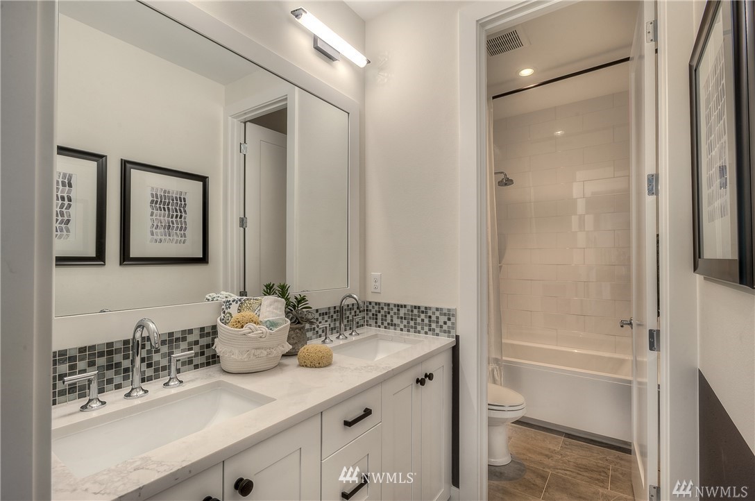21634 35th Avenue Southeast, Unit 20 Bothell, WA 98021 - Photo 8 of 14 a bathroom with a granite countertop sink and a mirror
