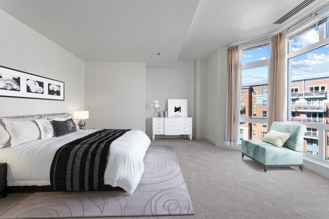 a spacious bedroom with a bed and a couch