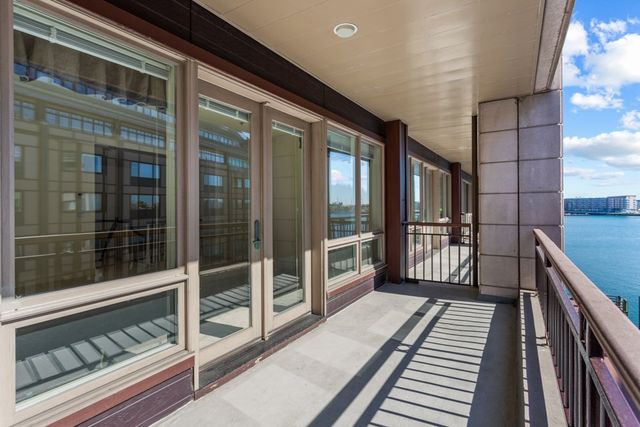 a view of a balcony with furniture and front door
