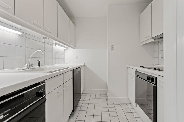 a utility room with sink dryer and washer