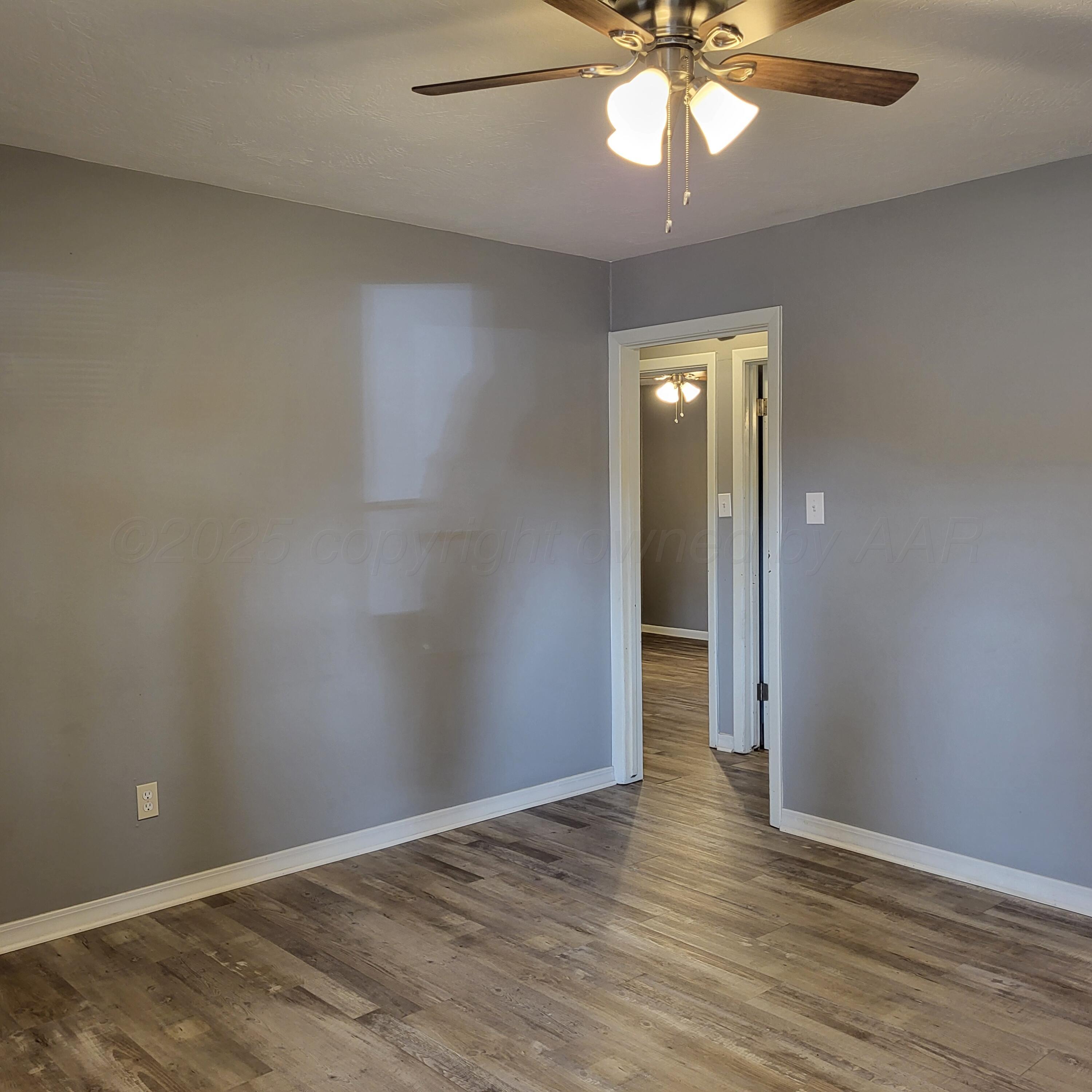 609 16th Street, Unit 4 Canyon, TX 79015 - Photo 2 of 9 wooden floor in an empty room