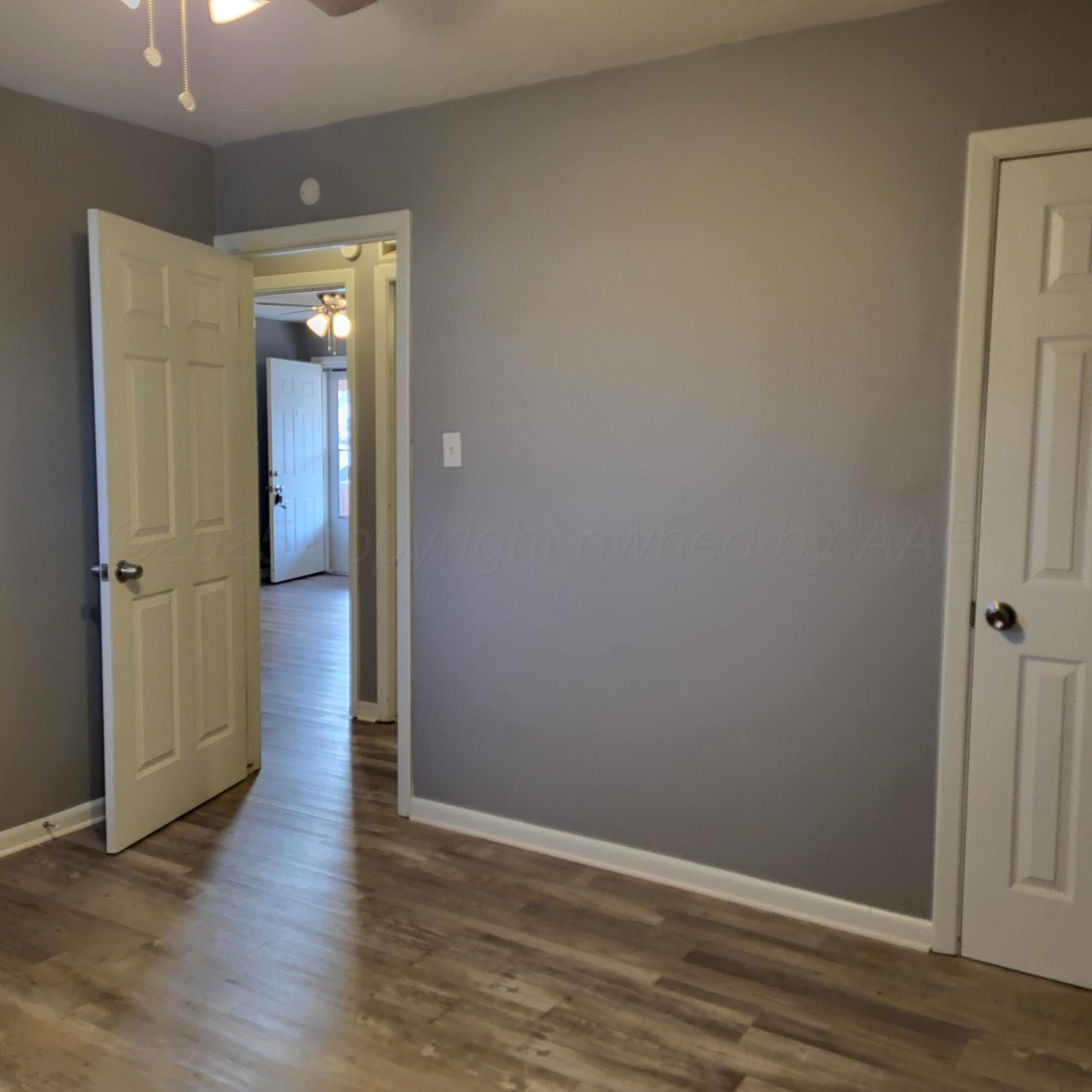 609 16th Street, Unit 4 Canyon, TX 79015 - Photo 7 of 9 wooden floor in an empty room