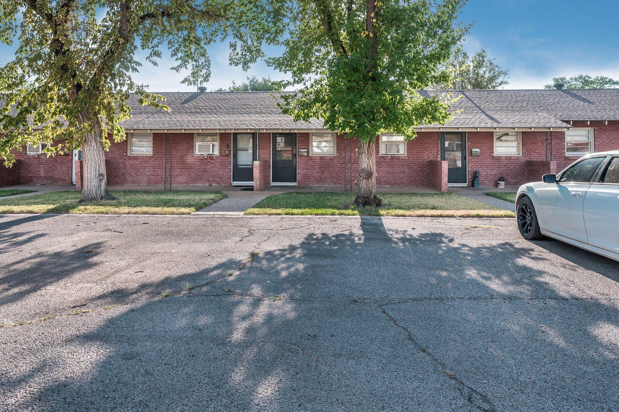 609 16th Street, Unit 4 Canyon, TX 79015 - Photo 8 of 9 a view of a house with a yard and large tree