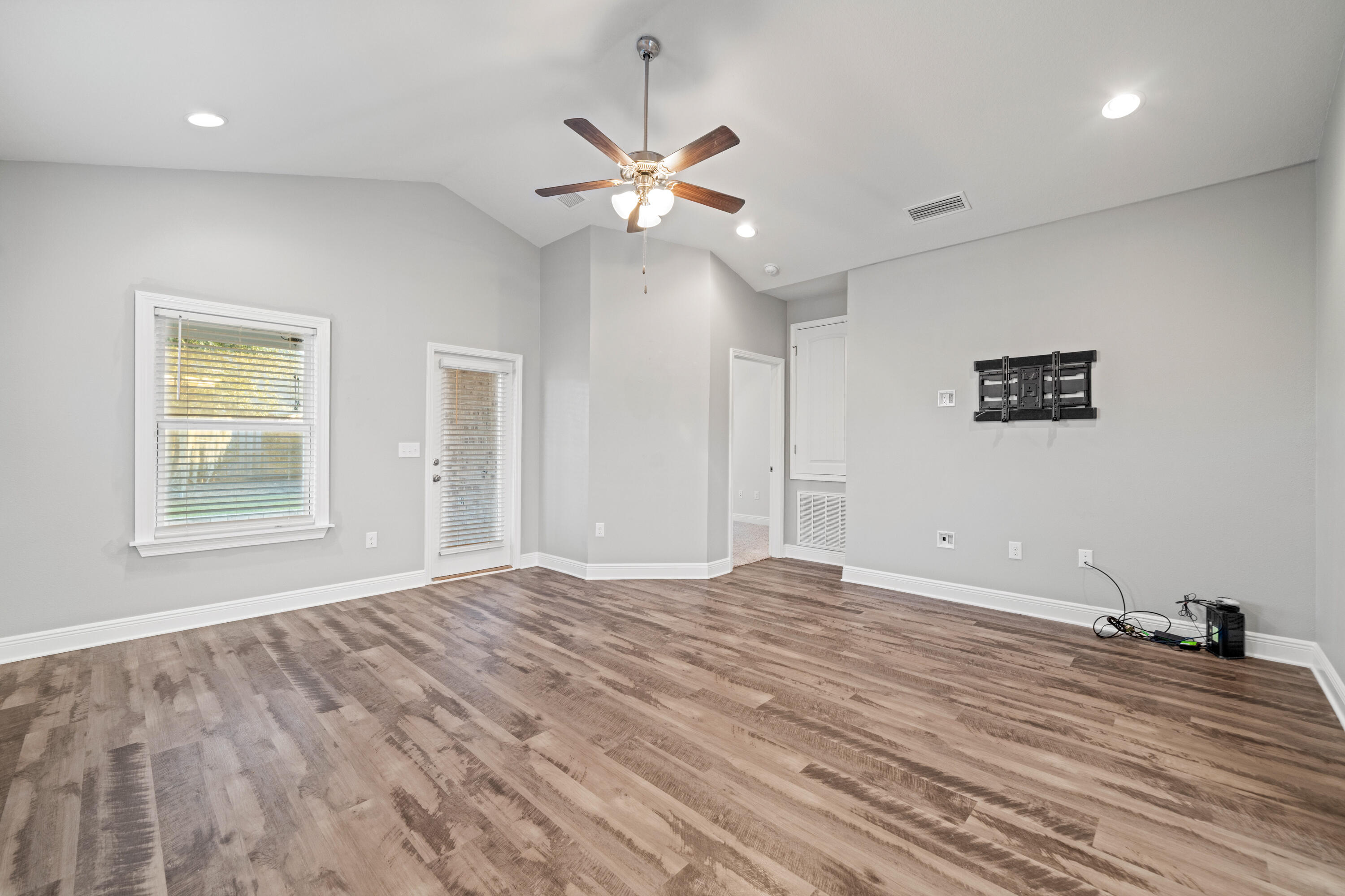 521 Cornelia Street Freeport, FL 32439 - Photo 17 of 39 a view of an empty room with window and wooden floor