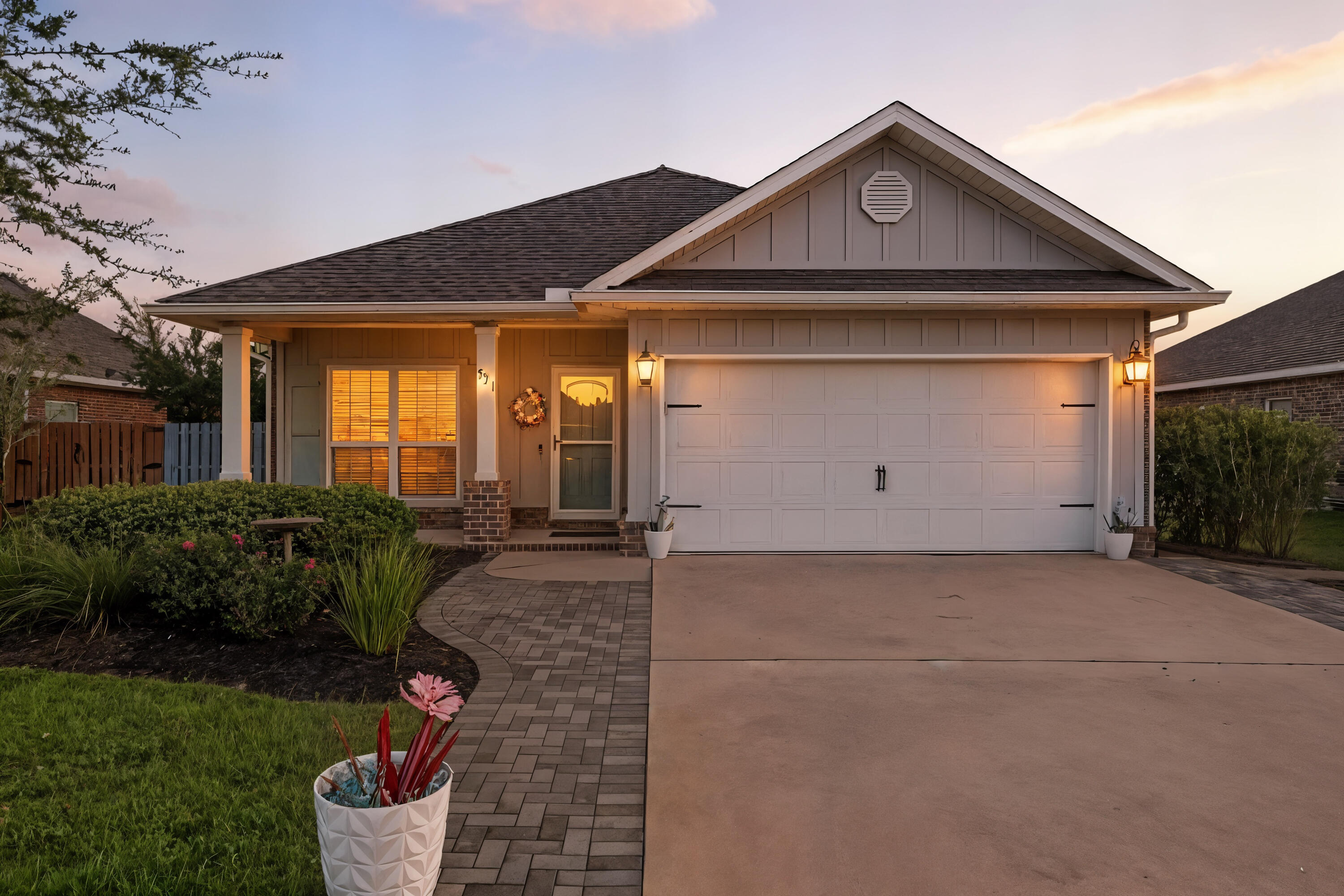 521 Cornelia Street Freeport, FL 32439 - Photo 2 of 39 a front view of a house with garden