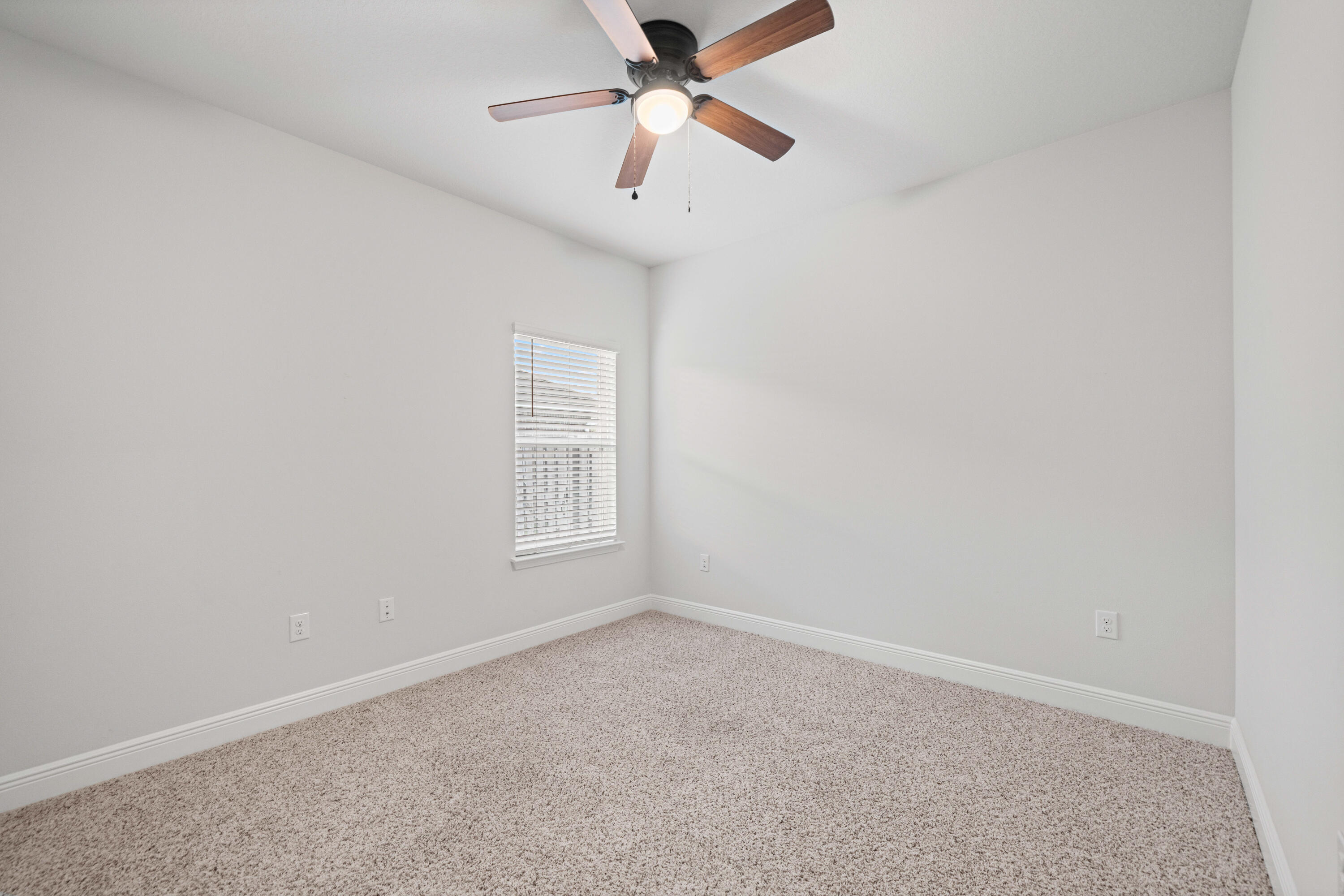 521 Cornelia Street Freeport, FL 32439 - Photo 26 of 39 an empty room with a window and a fan