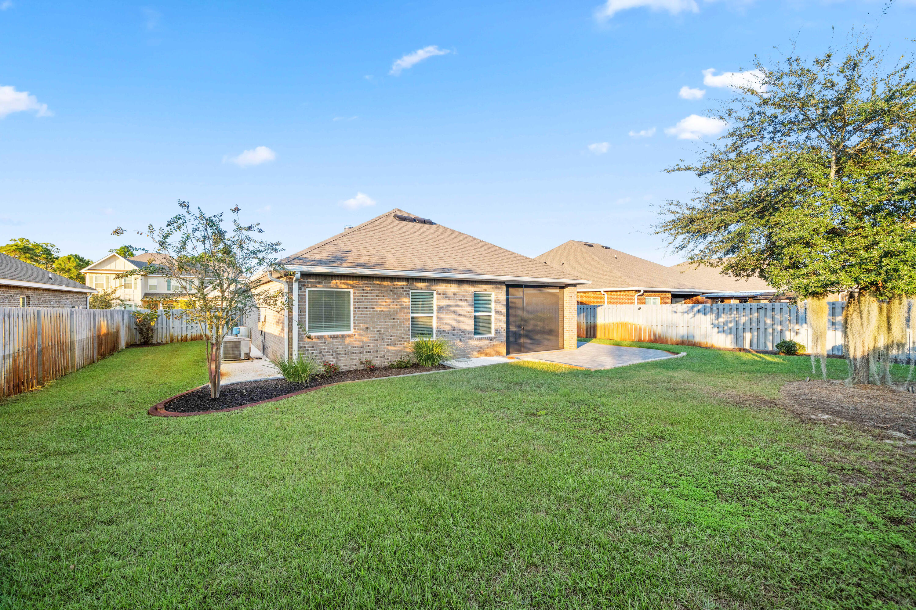 521 Cornelia Street Freeport, FL 32439 - Photo 3 of 39 a front view of a house with a garden and yard