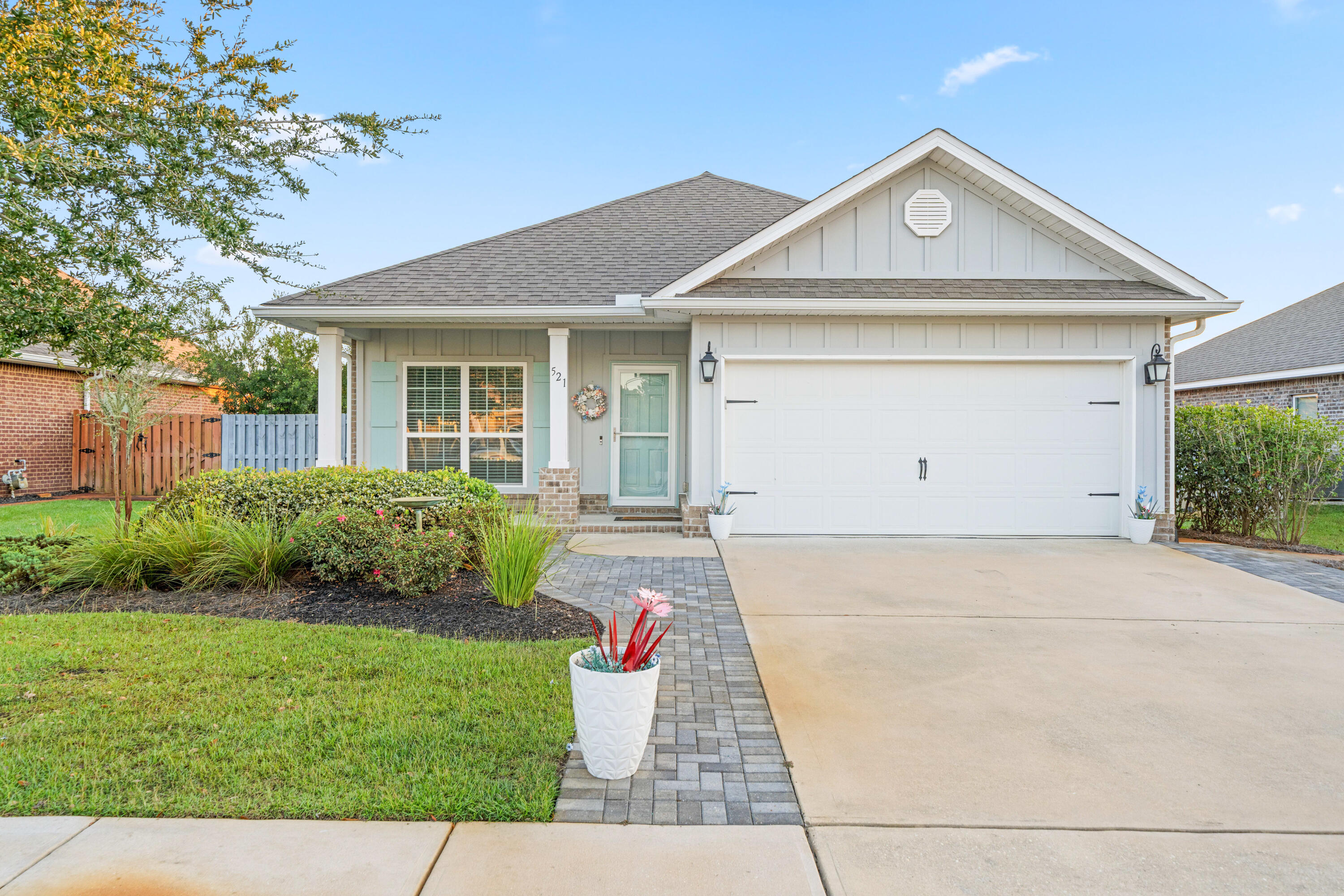 521 Cornelia Street Freeport, FL 32439 - Photo 31 of 39 a front view of a house with a yard and garage