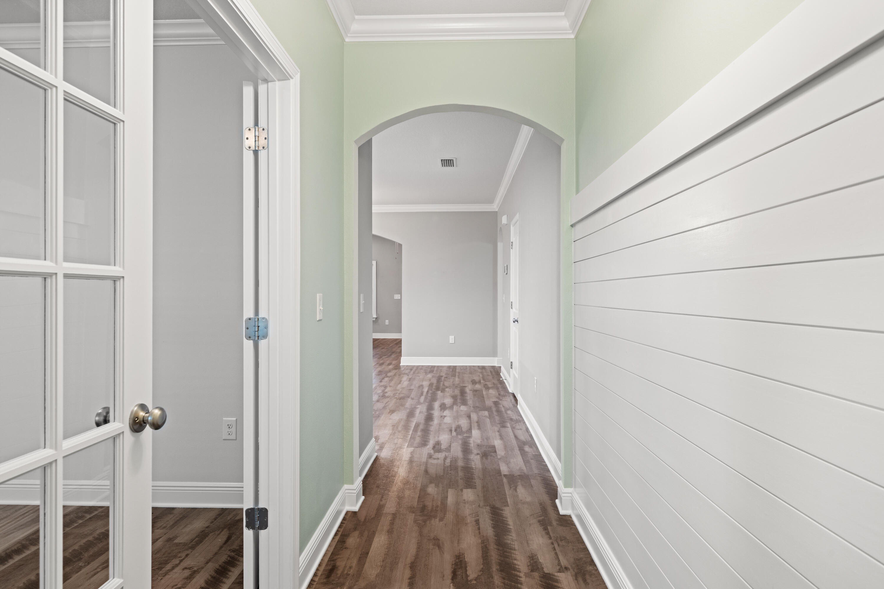 521 Cornelia Street Freeport, FL 32439 - Photo 8 of 39 a view of a hallway with wooden floor and staircase