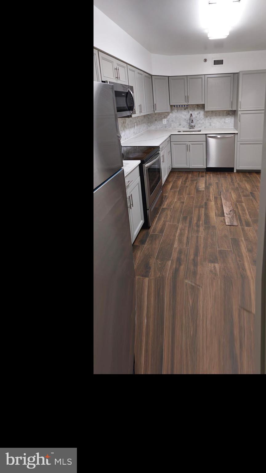 5501 Seminary Road, Unit 2502S Falls Church, VA 22041 - Photo 31 of 32 a kitchen with a stove top oven and white cabinets