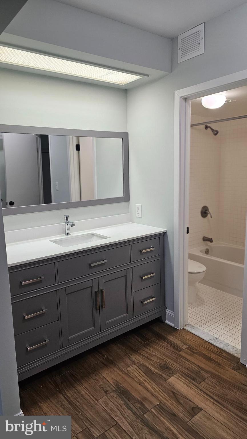 5501 Seminary Road, Unit 2502S Falls Church, VA 22041 - Photo 6 of 32 a bathroom with a granite countertop sink and a mirror