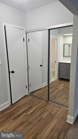 a view of a room with wooden floor and bathroom