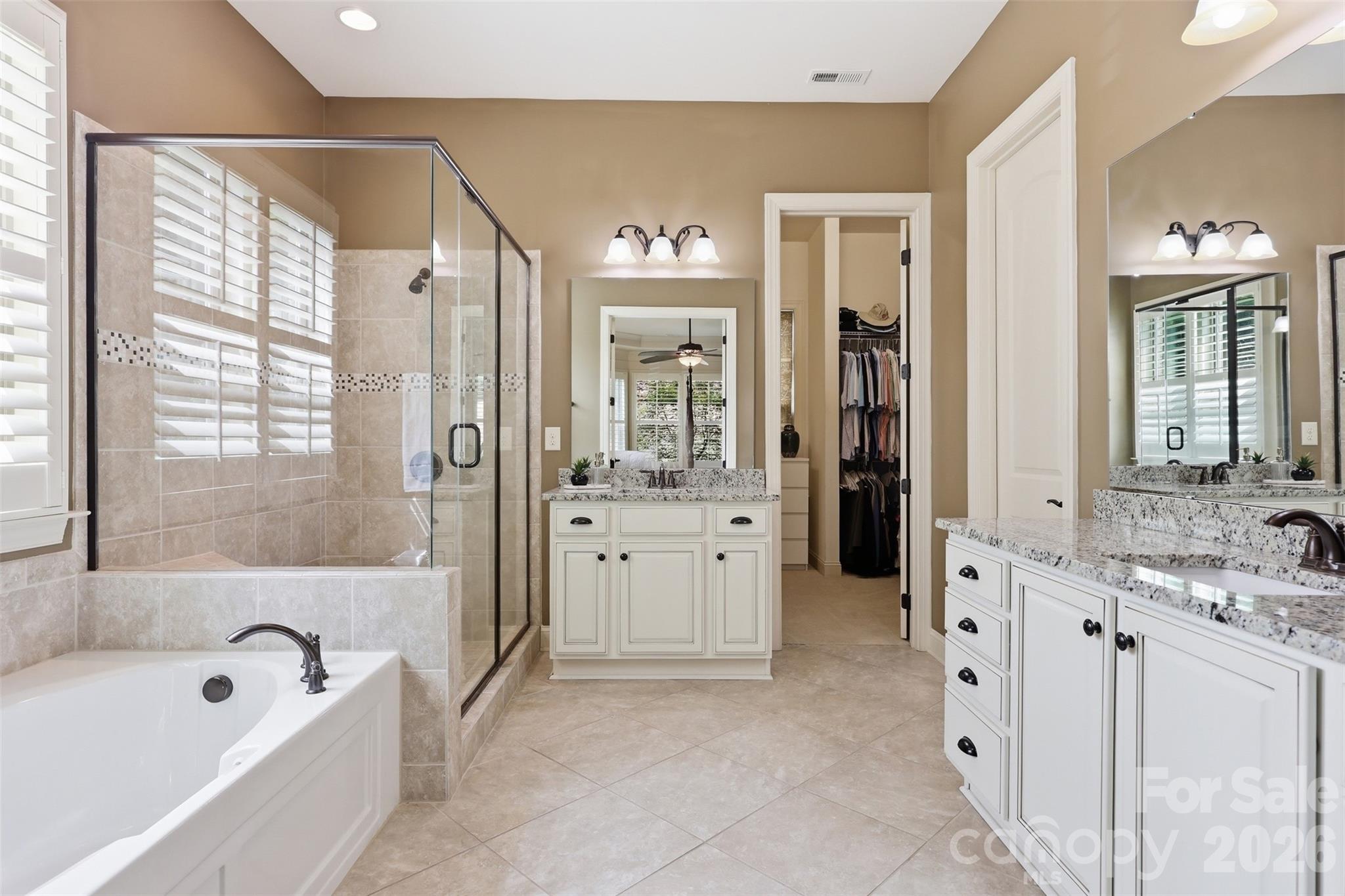 8094 Clems Branch Road Indian Land, SC 29707 - Photo 8 of 38 a bathroom with a tub a sink and mirrors