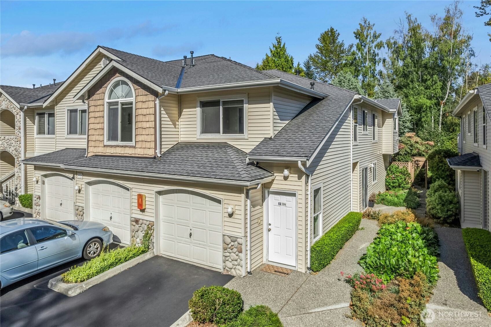 725 115th Street Southwest, Unit BB 204 Everett, WA 98204 - Photo 1 of 32 a view of a white house with large windows and a car parked in front of it