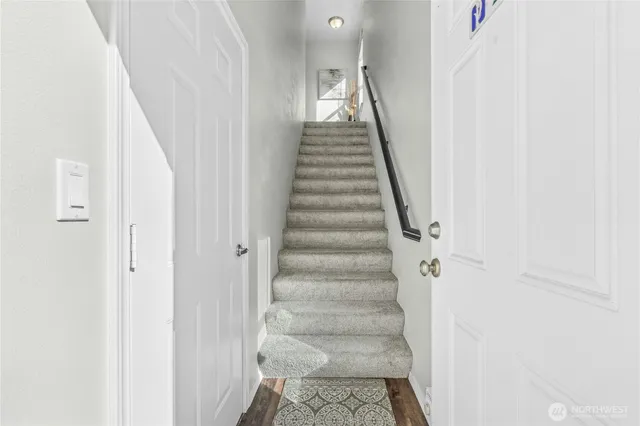 a view of staircase with white walls