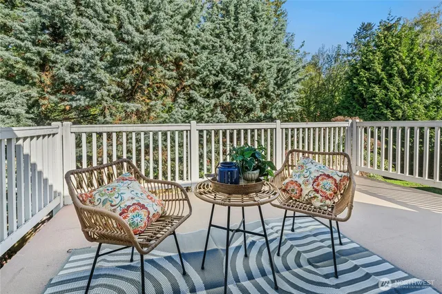 a view of a chairs and table in the balcony