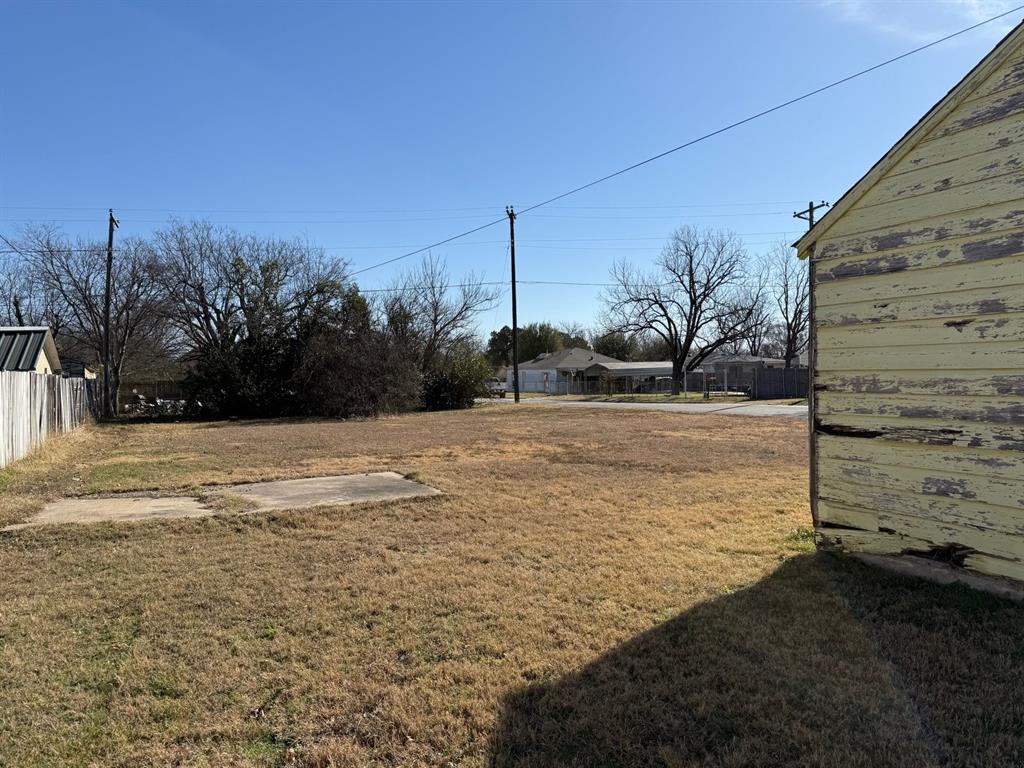 636 South Center Street Grand Prairie, TX 75051 - Photo 25 of 29 Large deep backyard beyond the single car garage.