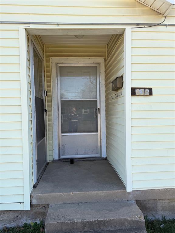 636 South Center Street Grand Prairie, TX 75051 - Photo 7 of 29 Front porch with entry doors into Living Area and Primary Bedroom.
