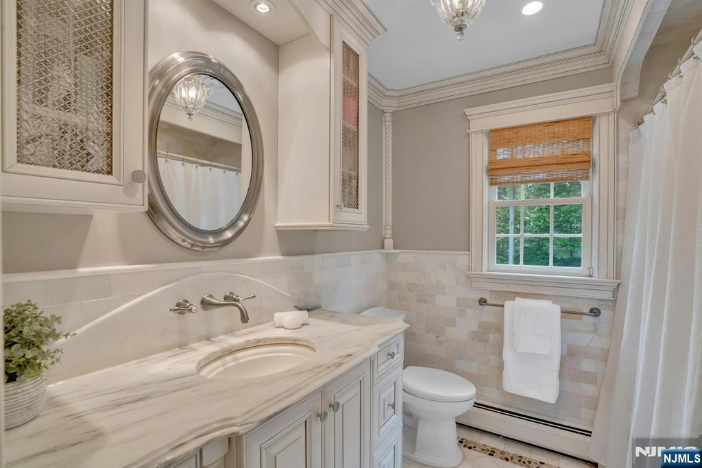 48 Hopper Farm Road Upper Saddle River, NJ 07458 - Photo 20 of 43 a bathroom with a sink and a toilet