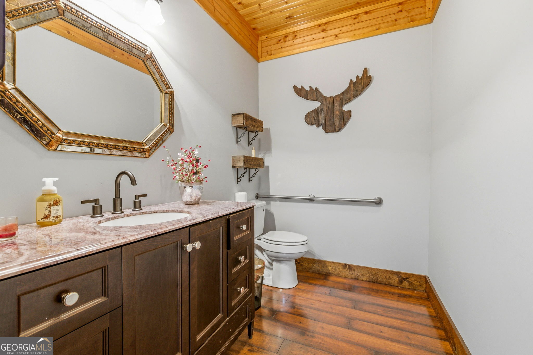 401 Herrin Road Cornelia, GA 30531 - Photo 65 of 83 a bathroom with a granite countertop sink mirror vanity and toilet